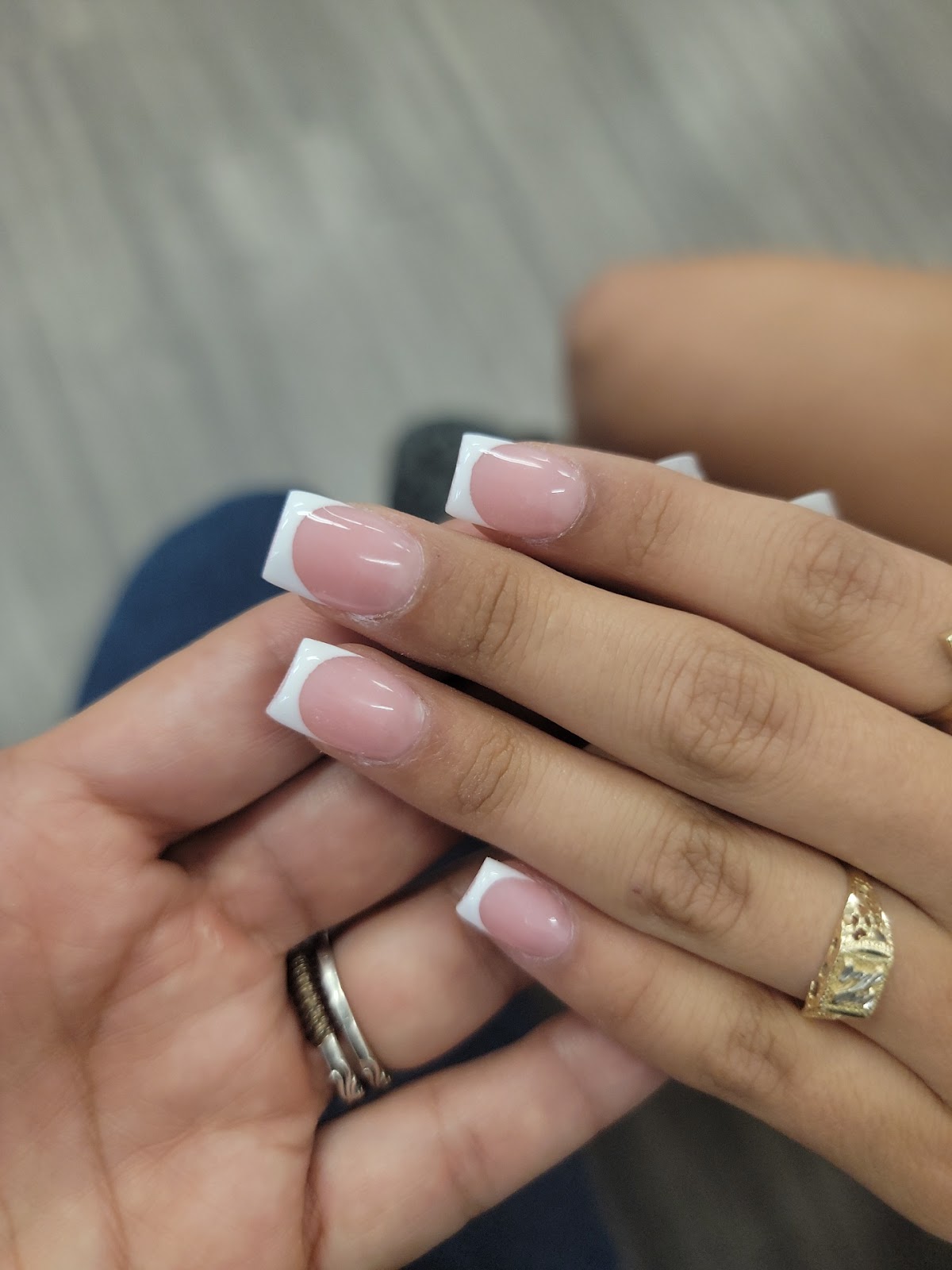 Elegant French-tip manicure done at Regal Nails